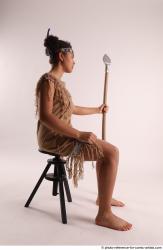 Woman Young Average Black Fighting with spear Sitting poses Casual